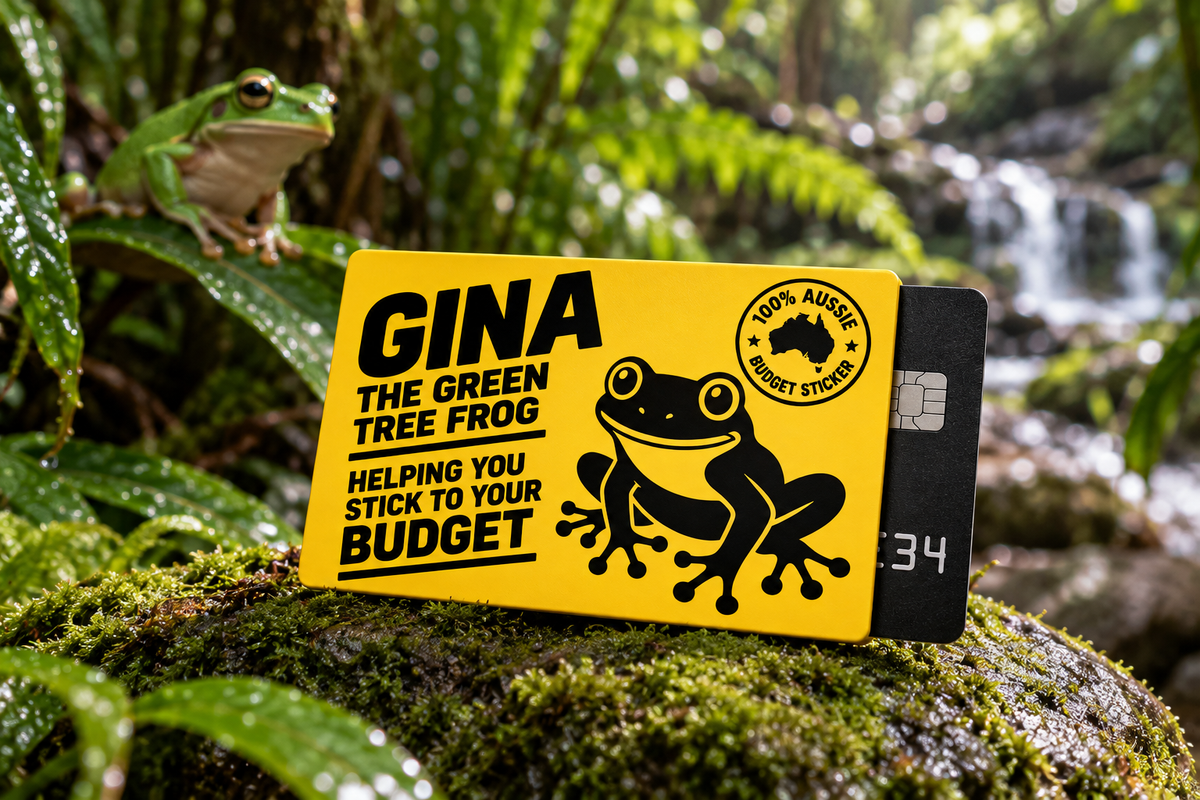Gina the Green Tree Frog yellow card sleeve resting on a moss-covered rock in a lush Daintree rainforest with a blurred green tree frog in the background.